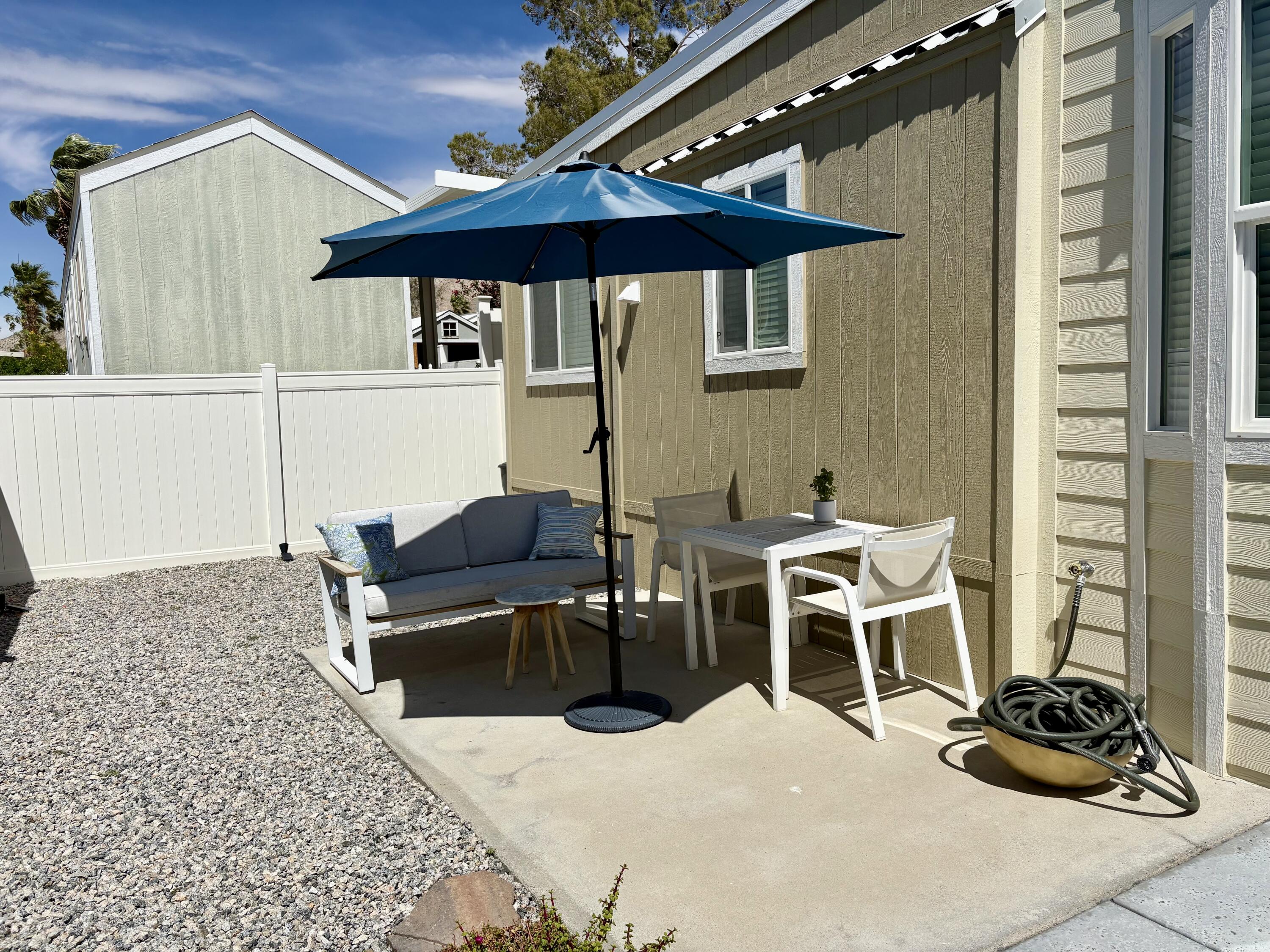 70200 Dillon Road, Unit 200 Desert Hot Springs, CA 92241 - Photo 24 of 31 a view of a patio with table and chairs