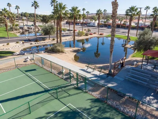 a view of a swimming pool with outdoor seating and city view