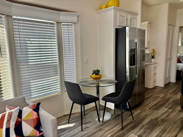 a dining room with furniture and wooden floor