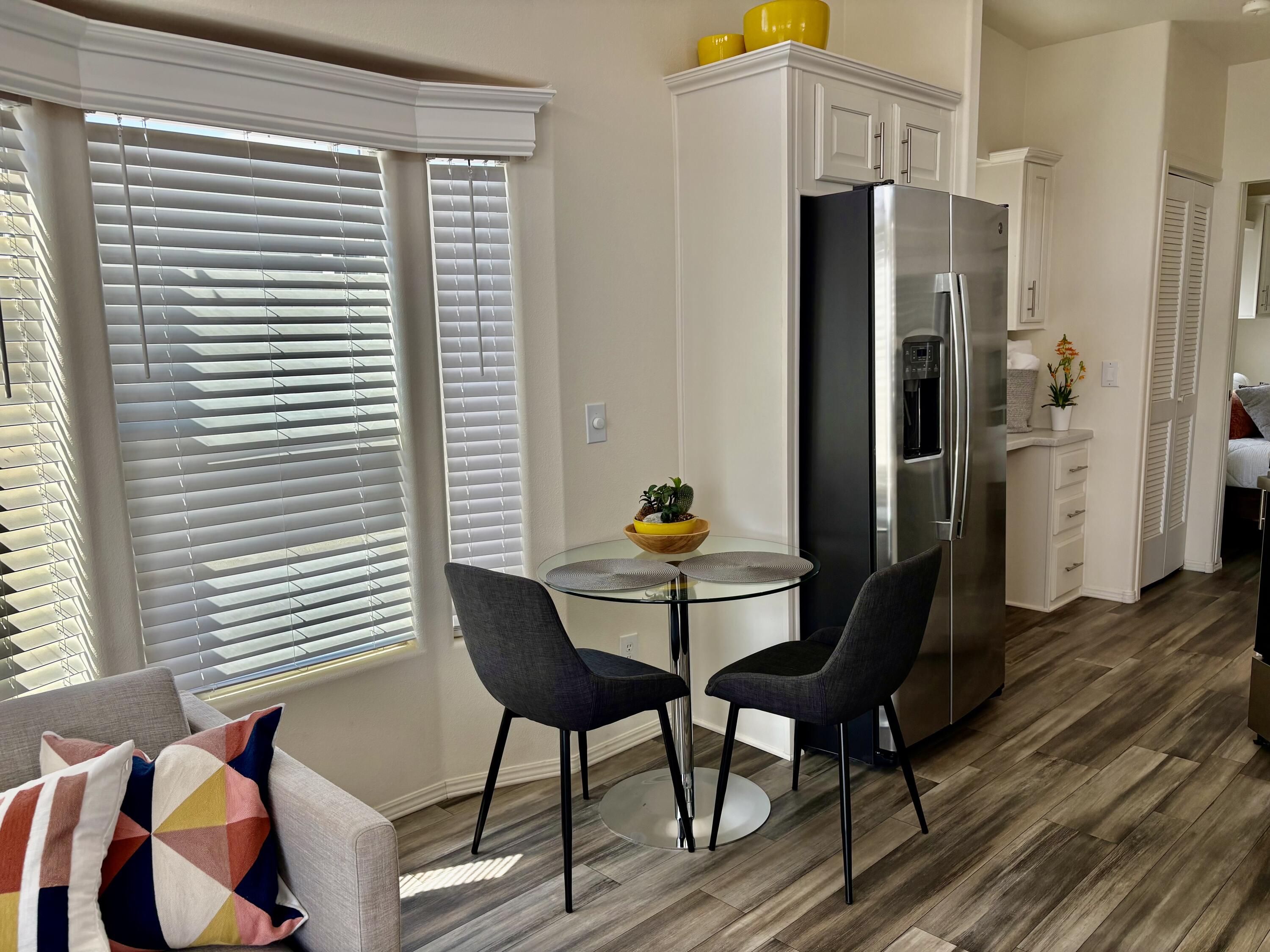 70200 Dillon Road, Unit 200 Desert Hot Springs, CA 92241 - Photo 6 of 31 a dining room with furniture and wooden floor