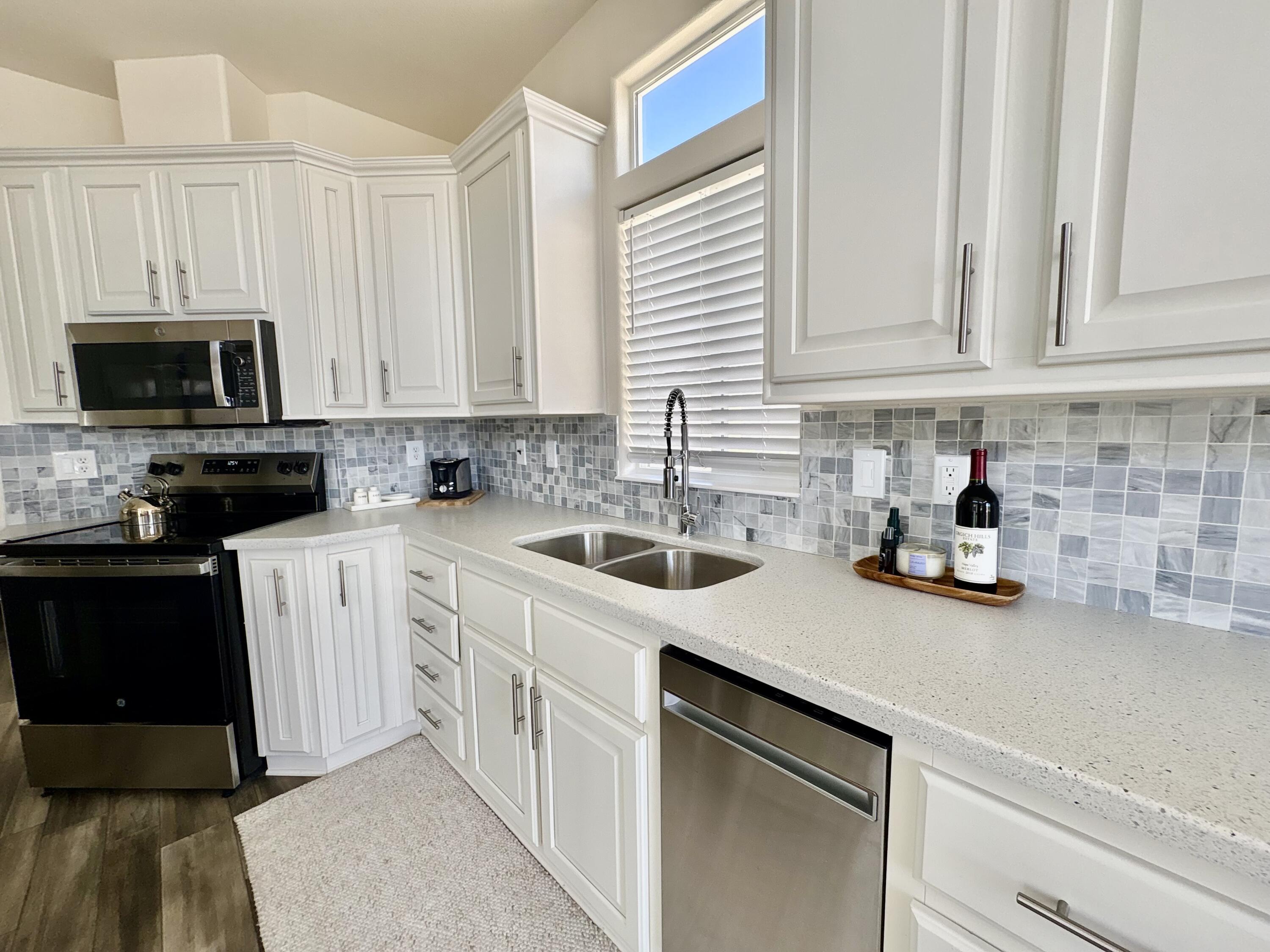 70200 Dillon Road, Unit 200 Desert Hot Springs, CA 92241 - Photo 8 of 31 a kitchen with white cabinets and white appliances