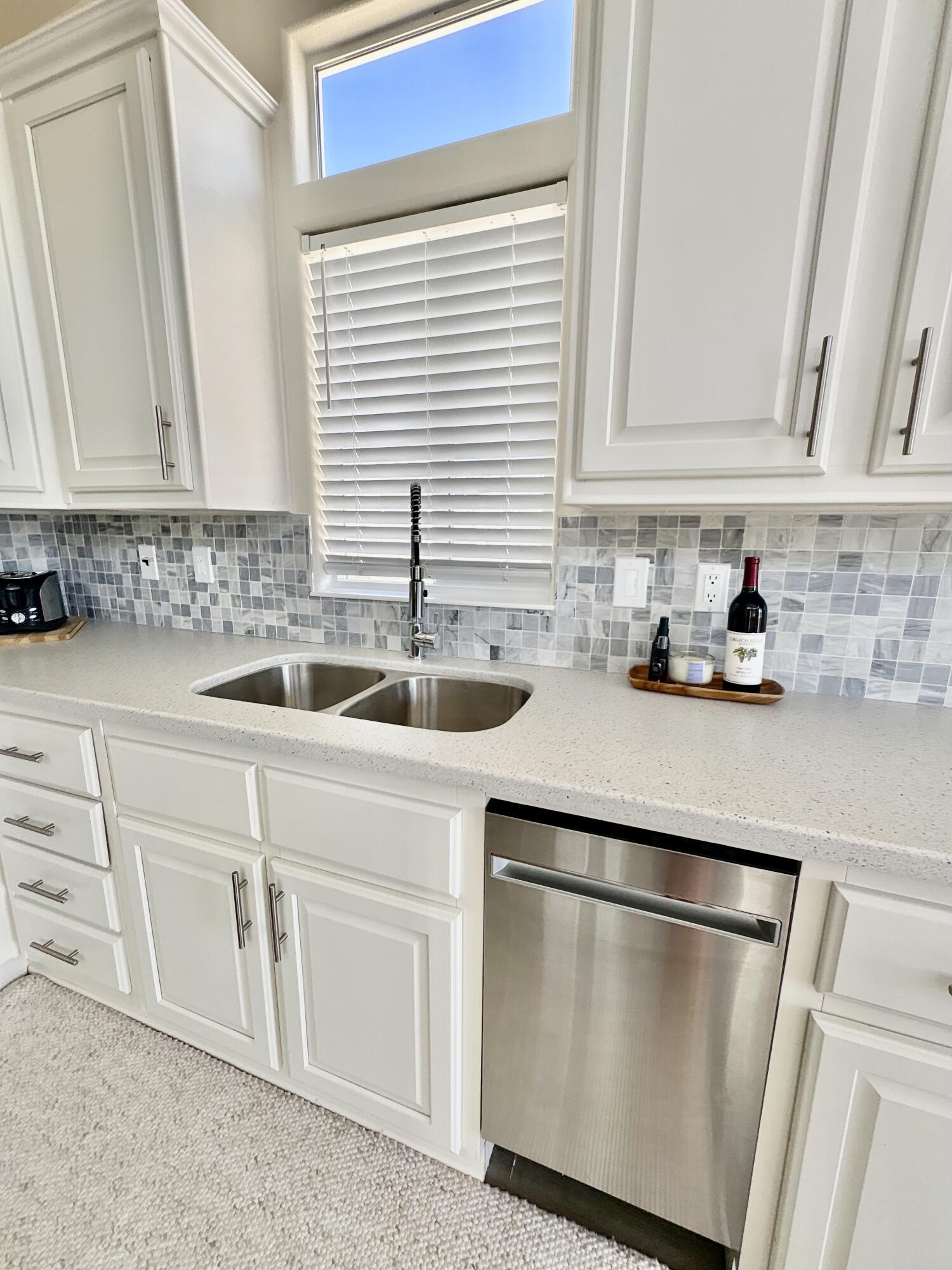 70200 Dillon Road, Unit 200 Desert Hot Springs, CA 92241 - Photo 9 of 31 a kitchen with white cabinets and sink