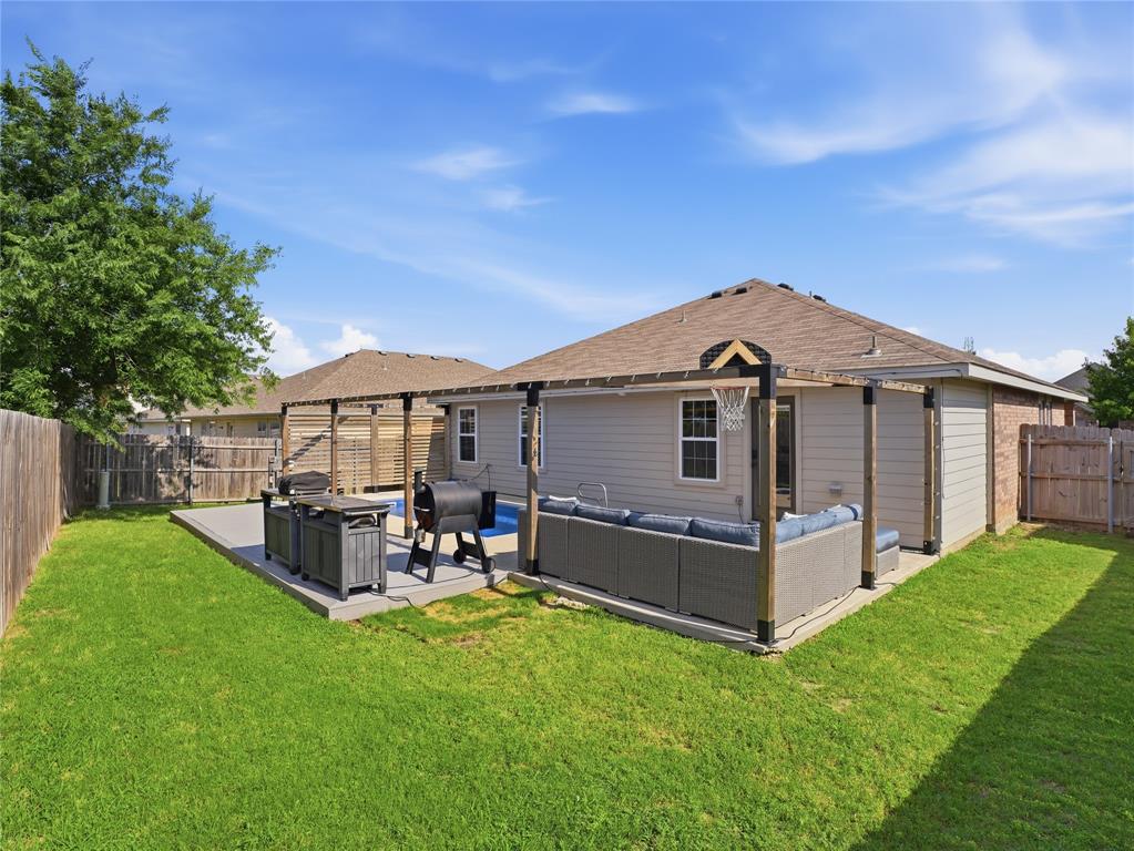 12724 Carpenter Lane Rhome, TX 76078 - Photo 28 of 37 Expansive backyard featuring a concrete patio, a pergola structure, and a fenced perimeter