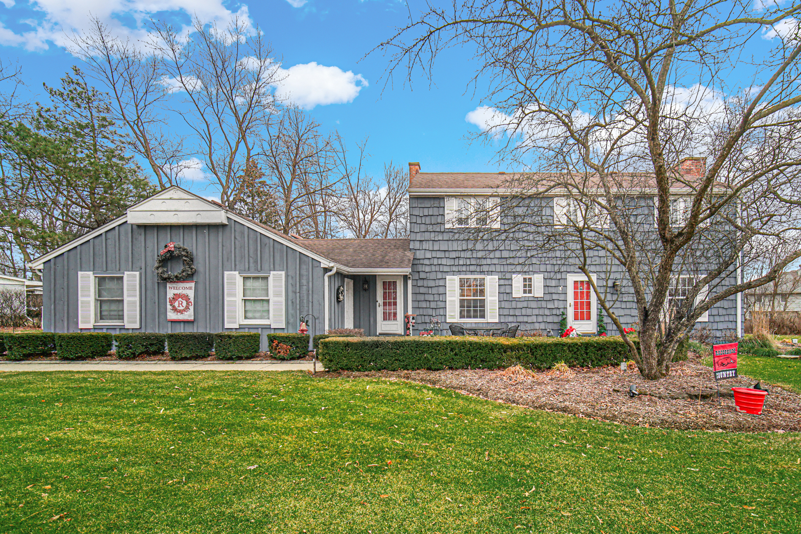 a front view of house with yard and green space
