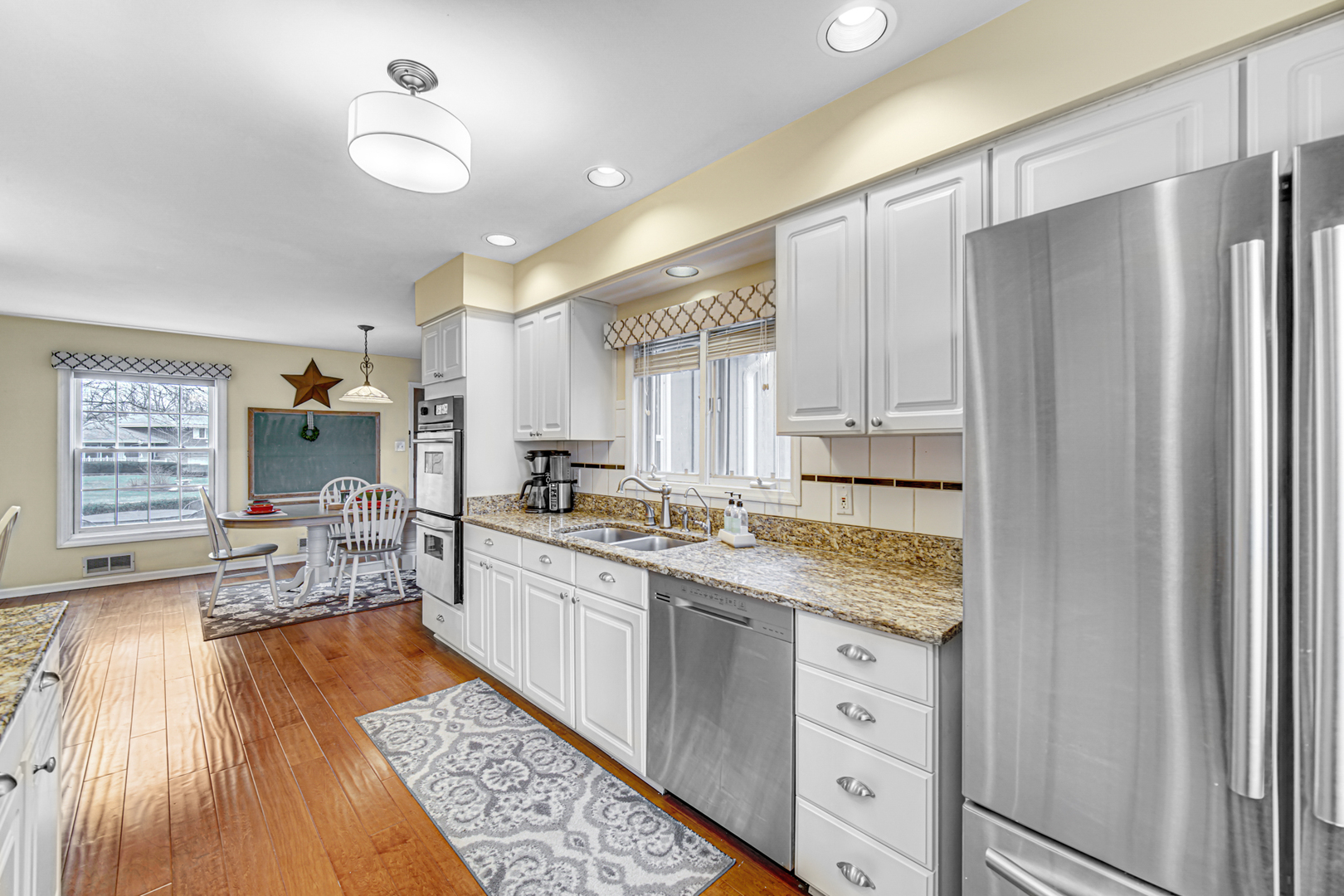 1910 Coventry Road New Lenox, IL 60451 - Photo 2 of 40 a kitchen with white cabinets and appliances