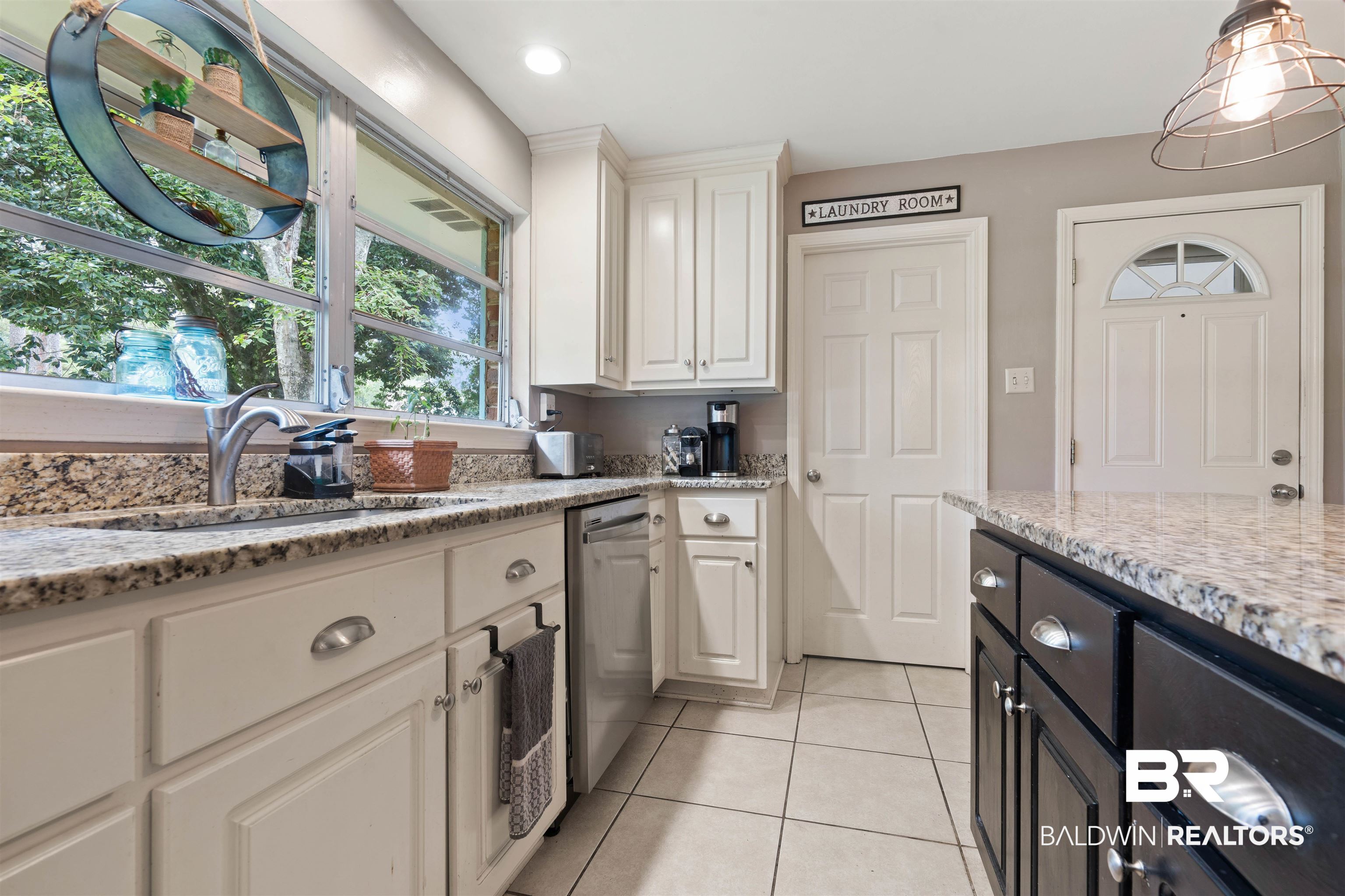4051 East Canal Circle Mobile, AL 36619 - Photo 12 of 32 Kitchen with white cabinets, sink, dishwasher, light stone counters, and light tile patterned floors