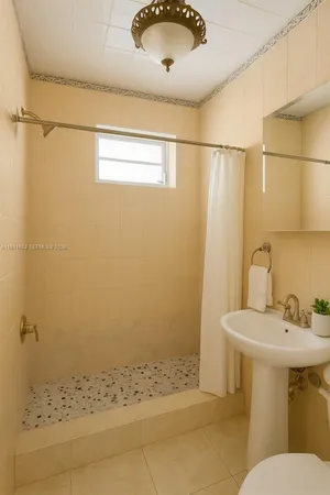 a bathroom with a sink toilet and mirror