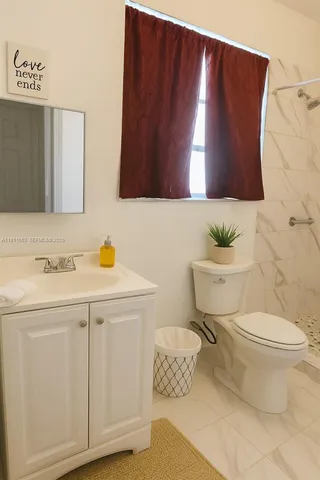 a bathroom with a sink toilet and mirror