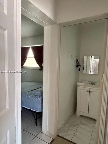 a room with washing machine and cabinet