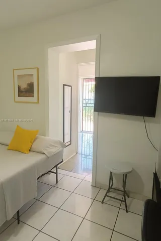 a bedroom with a bed and a potted plant