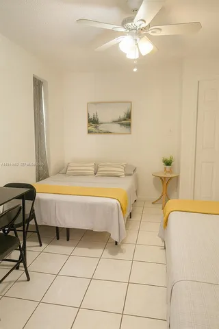 a spacious bedroom with a bed and table