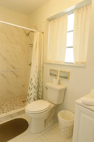 a bathroom with a toilet a sink and a shower