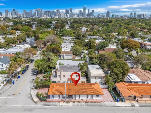 a view of a house with a yard and potted plants