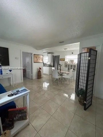 a living room with furniture a flat screen tv and a table