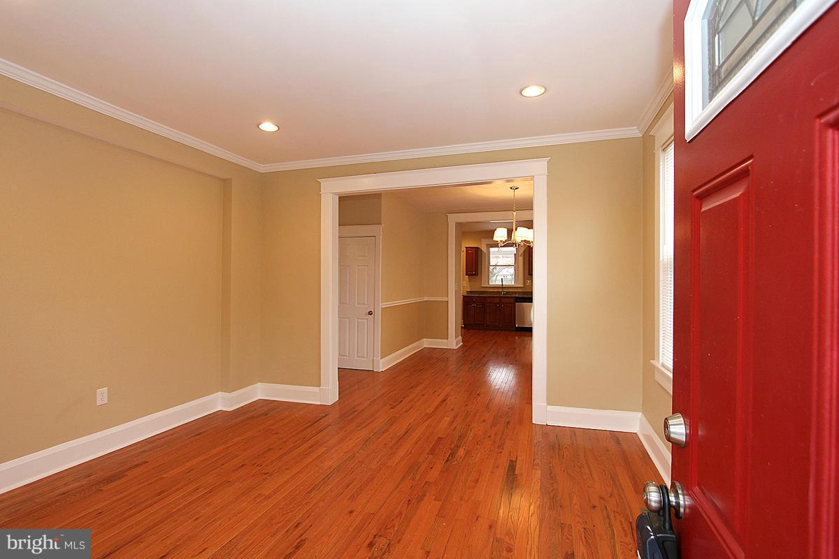 3106 Rueckert Avenue Baltimore, MD 21214 - Photo 3 of 29 a view of a hallway with wooden floor and a bathroom