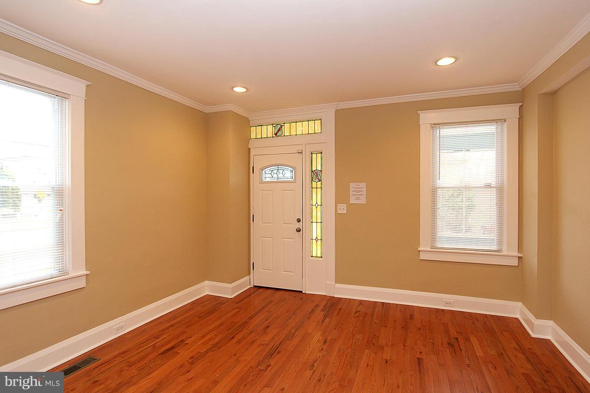 3106 Rueckert Avenue Baltimore, MD 21214 - Photo 4 of 29 an empty room with wooden floor and windows