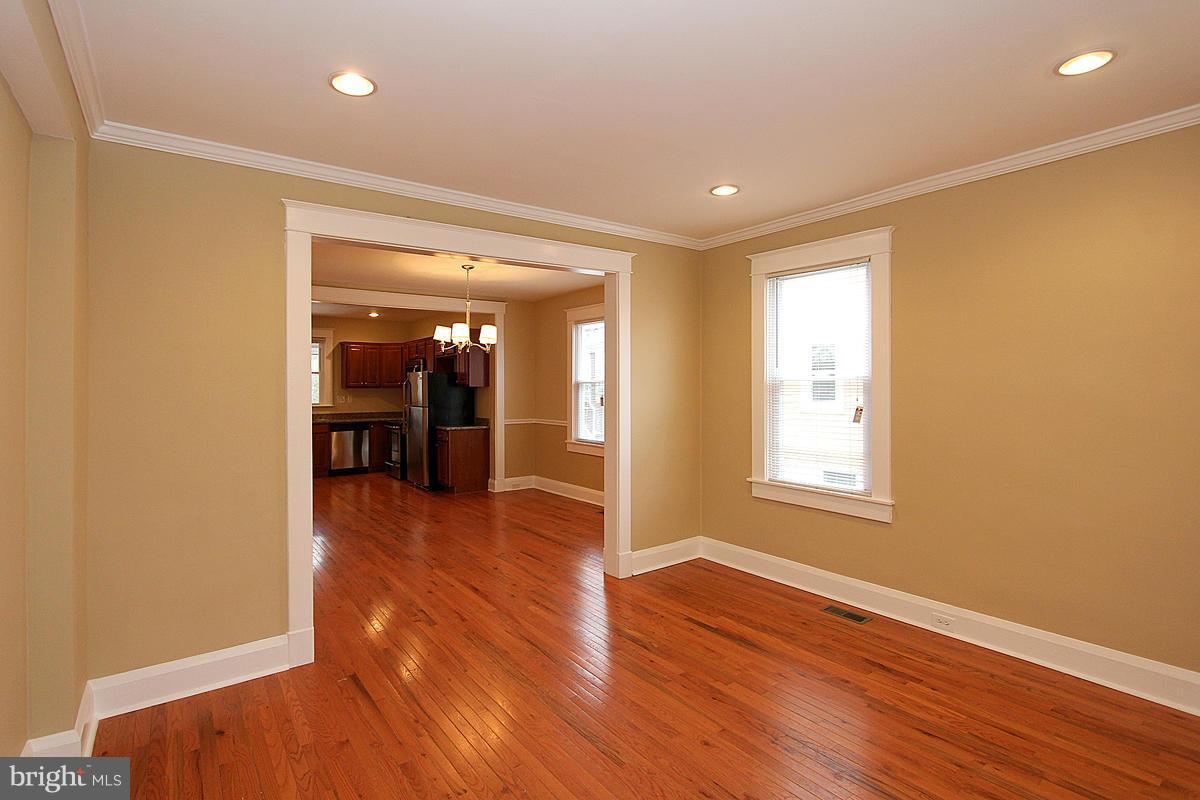 3106 Rueckert Avenue Baltimore, MD 21214 - Photo 5 of 29 wooden floor in an empty room with a window