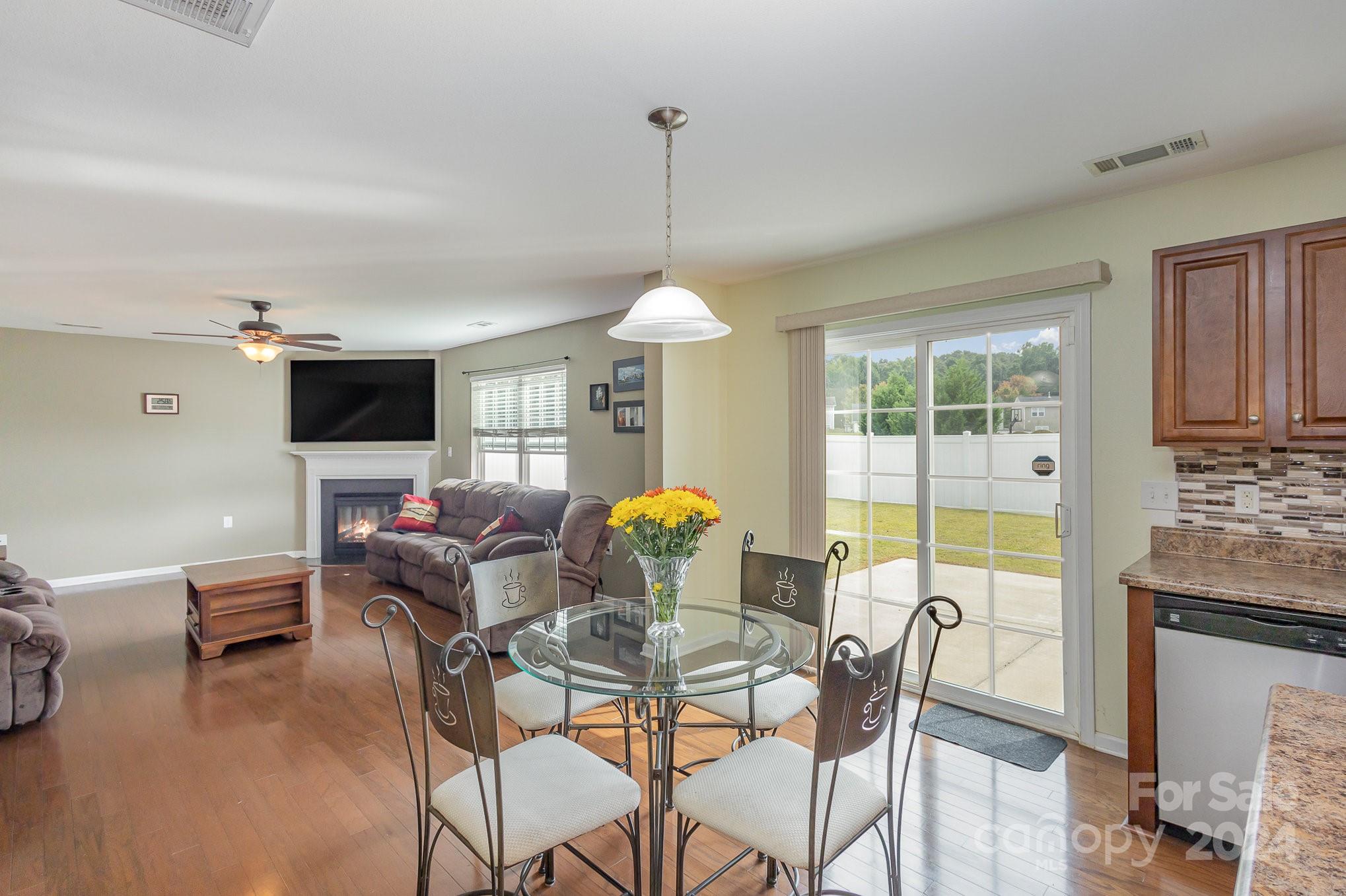 714 Waterlemon Way Monroe, NC 28110 - Photo 12 of 38 a dining room with furniture a chandelier and wooden floor