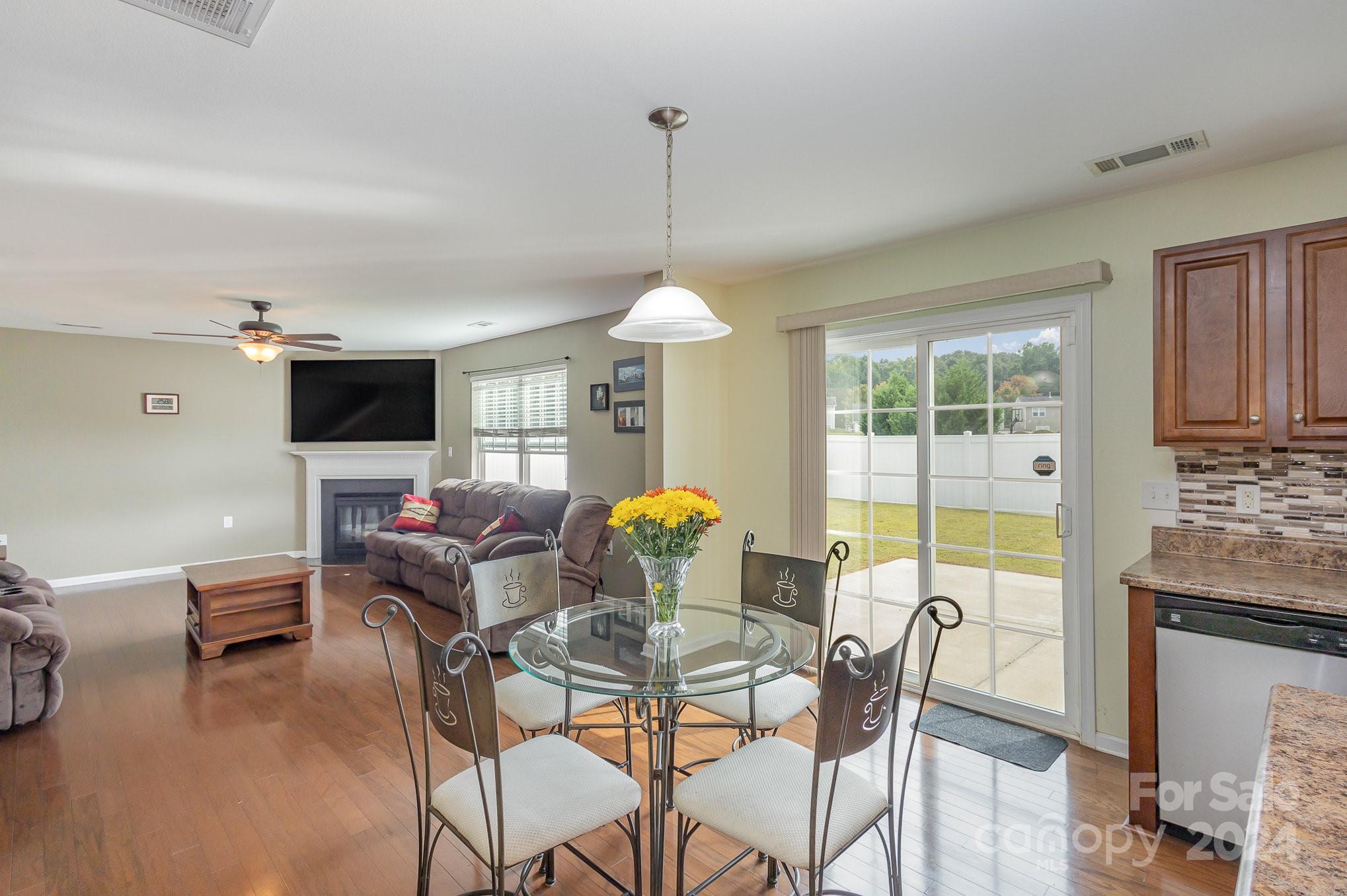 714 Waterlemon Way Monroe, NC 28110 - Photo 13 of 38 a dining room with furniture a chandelier and wooden floor