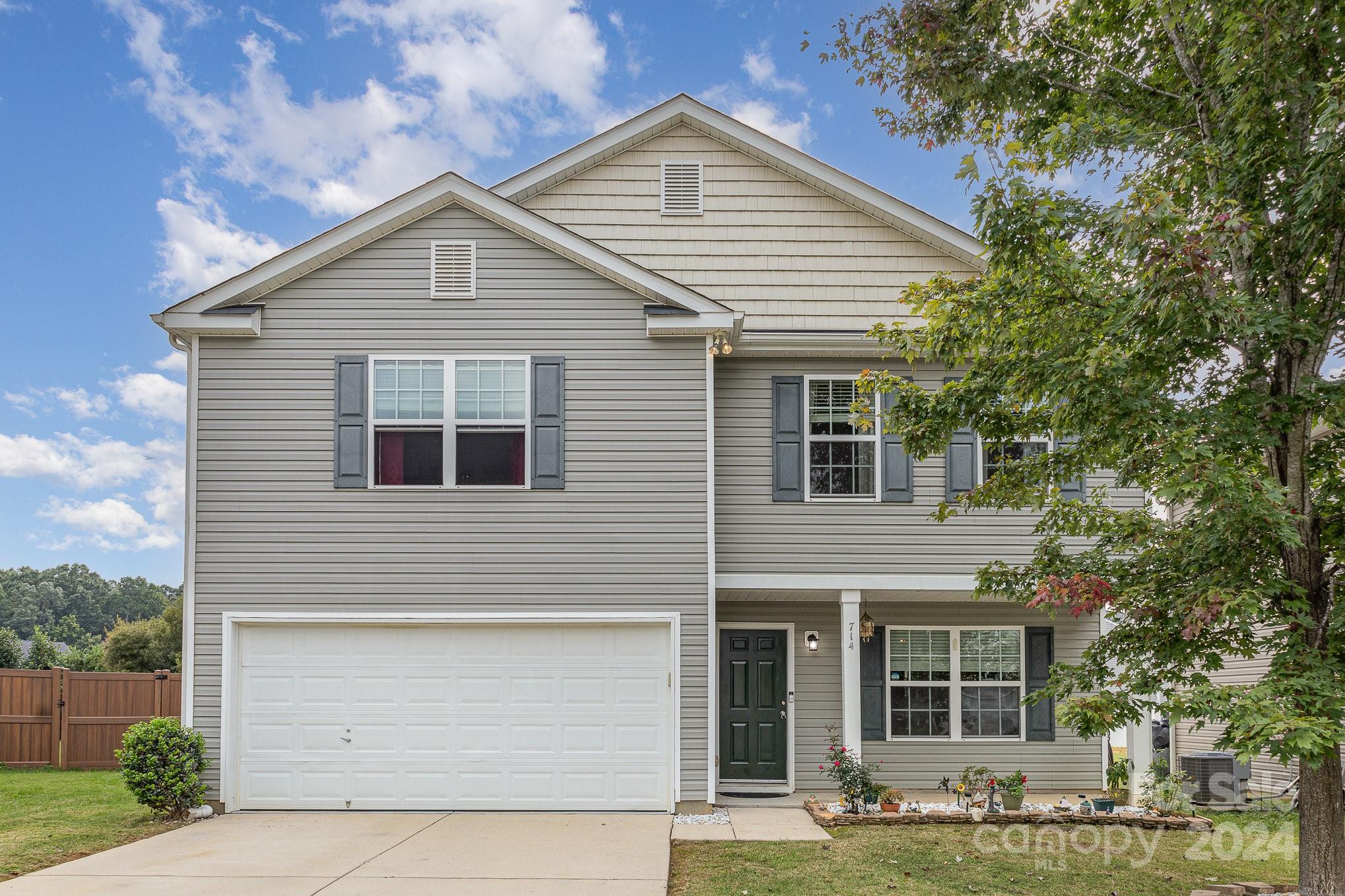 714 Waterlemon Way Monroe, NC 28110 - Photo 2 of 38 a view of a house with a yard and large tree