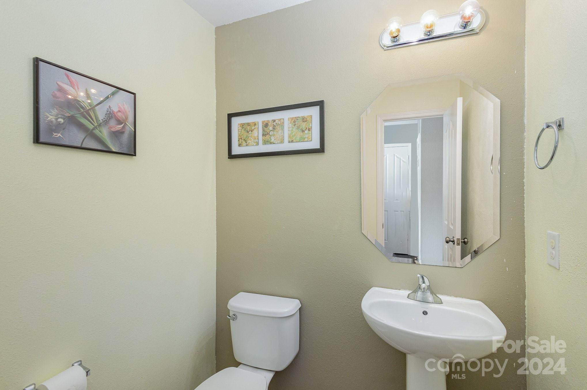714 Waterlemon Way Monroe, NC 28110 - Photo 21 of 38 a bathroom with a toilet sink and mirror