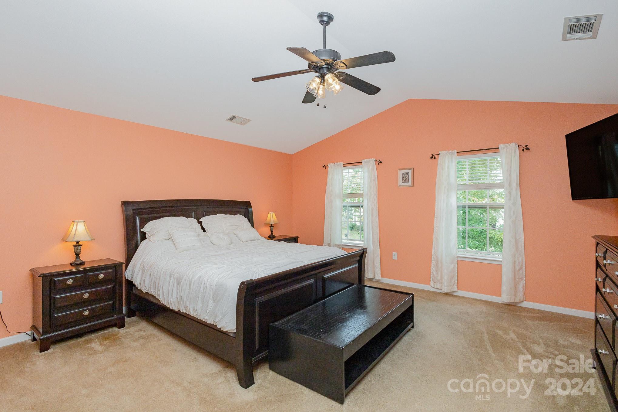 714 Waterlemon Way Monroe, NC 28110 - Photo 22 of 38 a bedroom with a bed and a flat tv screen on dresser