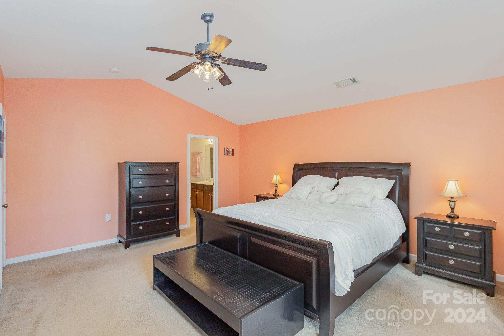 714 Waterlemon Way Monroe, NC 28110 - Photo 23 of 38 a bedroom with a bed and a chandelier