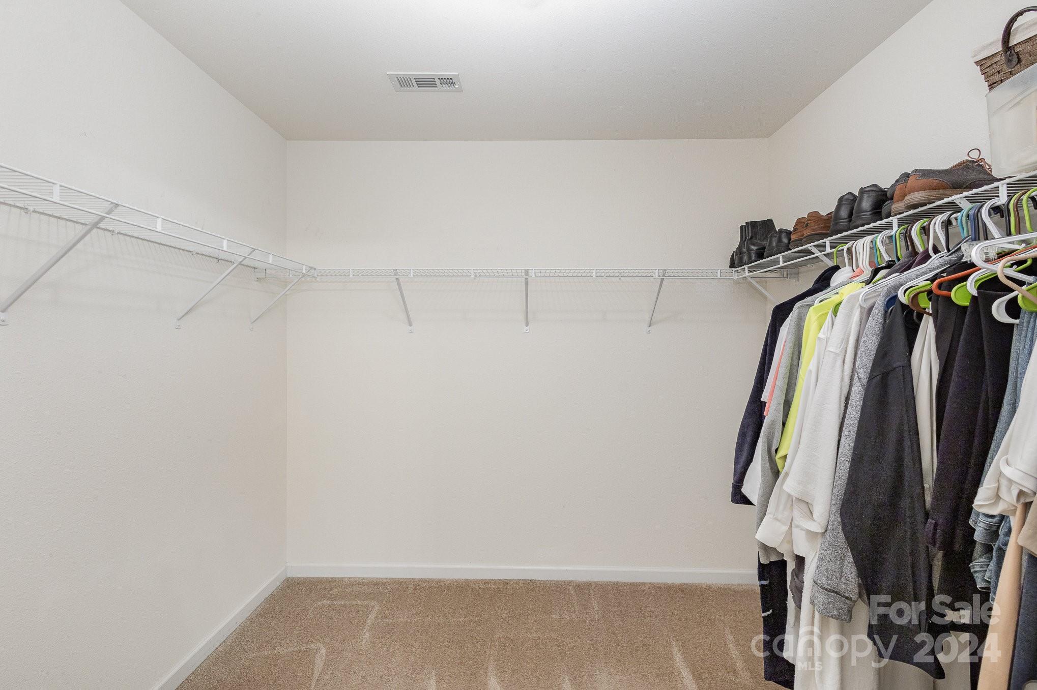 714 Waterlemon Way Monroe, NC 28110 - Photo 27 of 38 a view of walk in closet with clothes and shoes