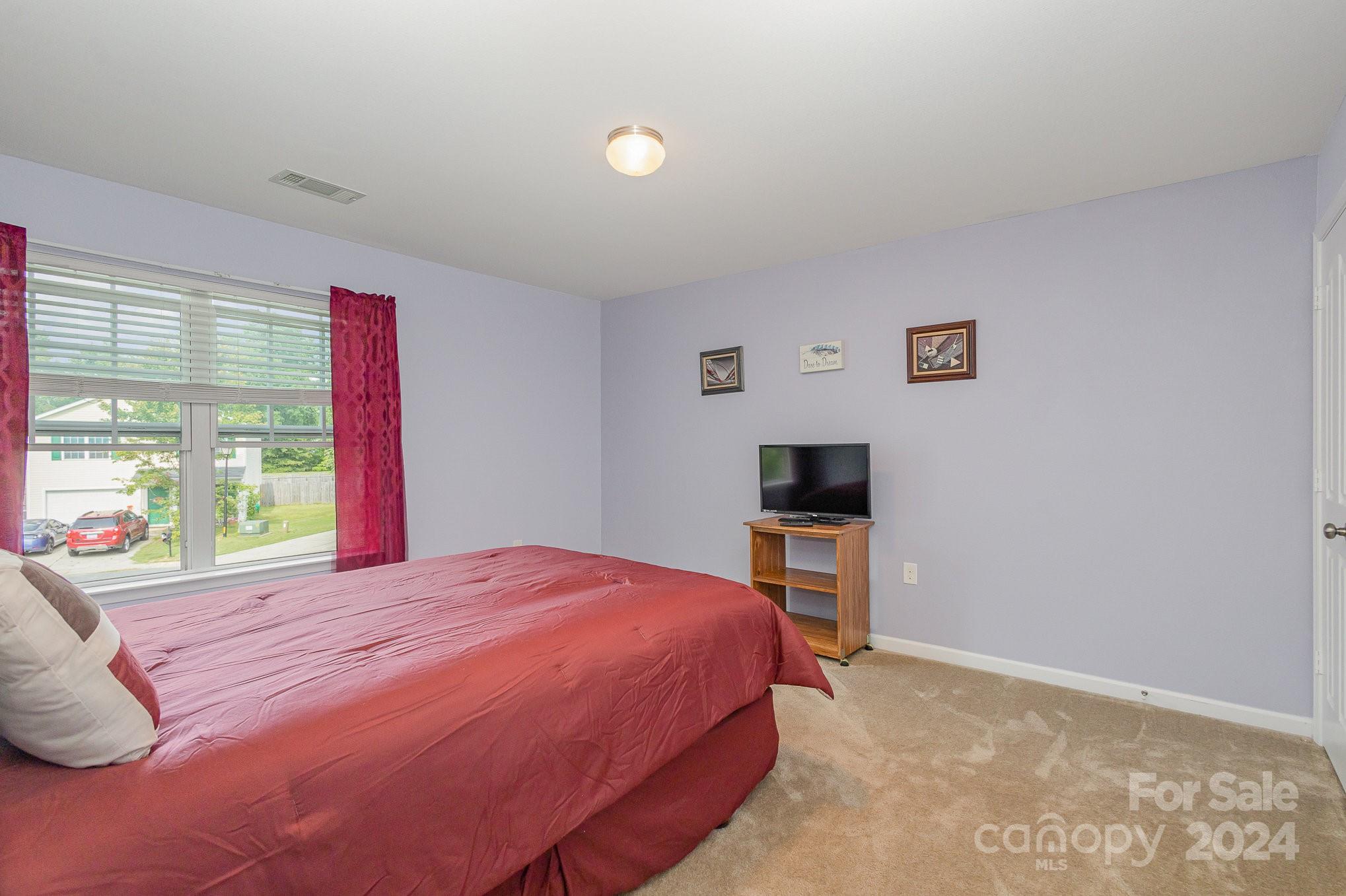 714 Waterlemon Way Monroe, NC 28110 - Photo 30 of 38 a bedroom with a bed and a tv