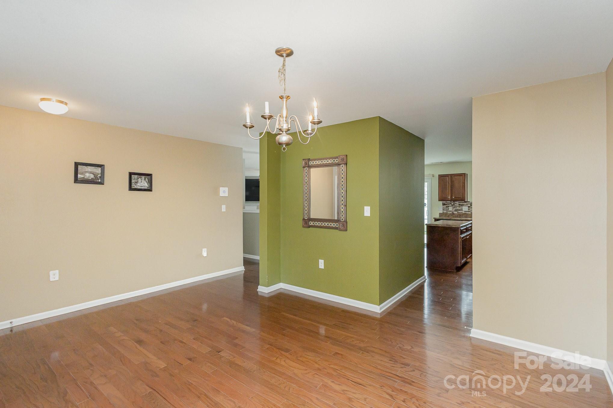 714 Waterlemon Way Monroe, NC 28110 - Photo 4 of 38 a view of a room with a fridge and wooden floor
