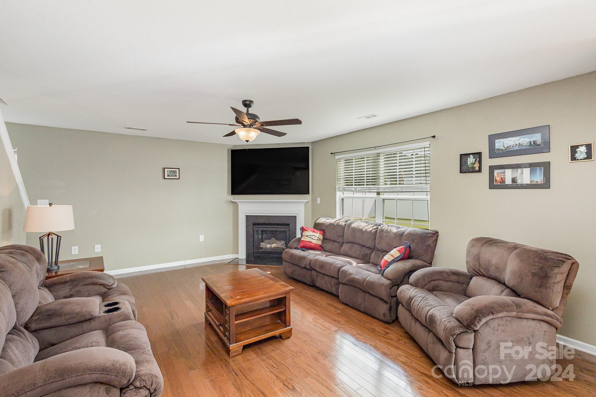 714 Waterlemon Way Monroe, NC 28110 - Photo 9 of 38 a living room with furniture and a flat screen tv