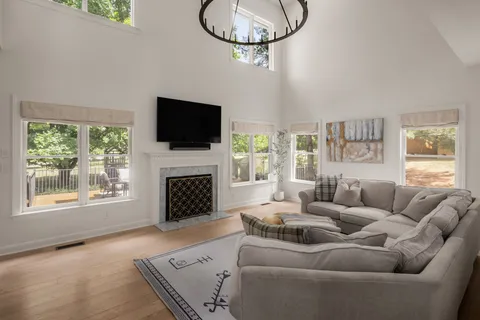 a living room with furniture a fireplace and a flat screen tv