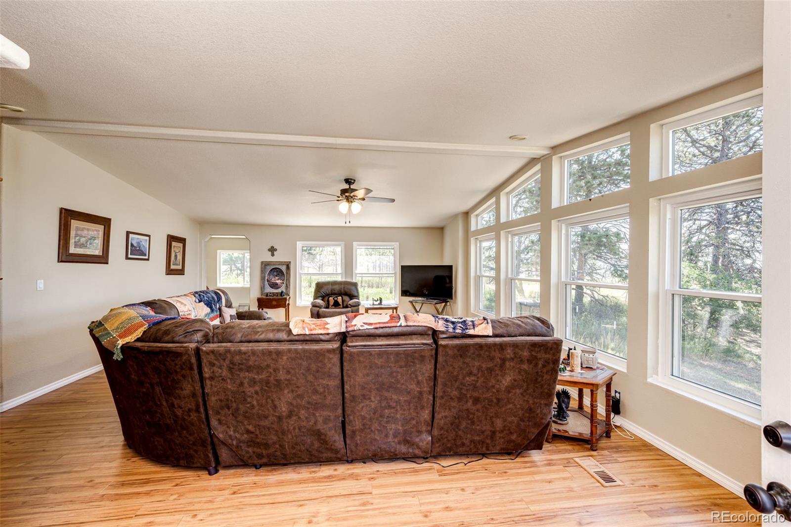 36810 View Ridge Drive Elizabeth, CO 80107 - Photo 17 of 46 a living room with furniture a flat screen tv and a large window