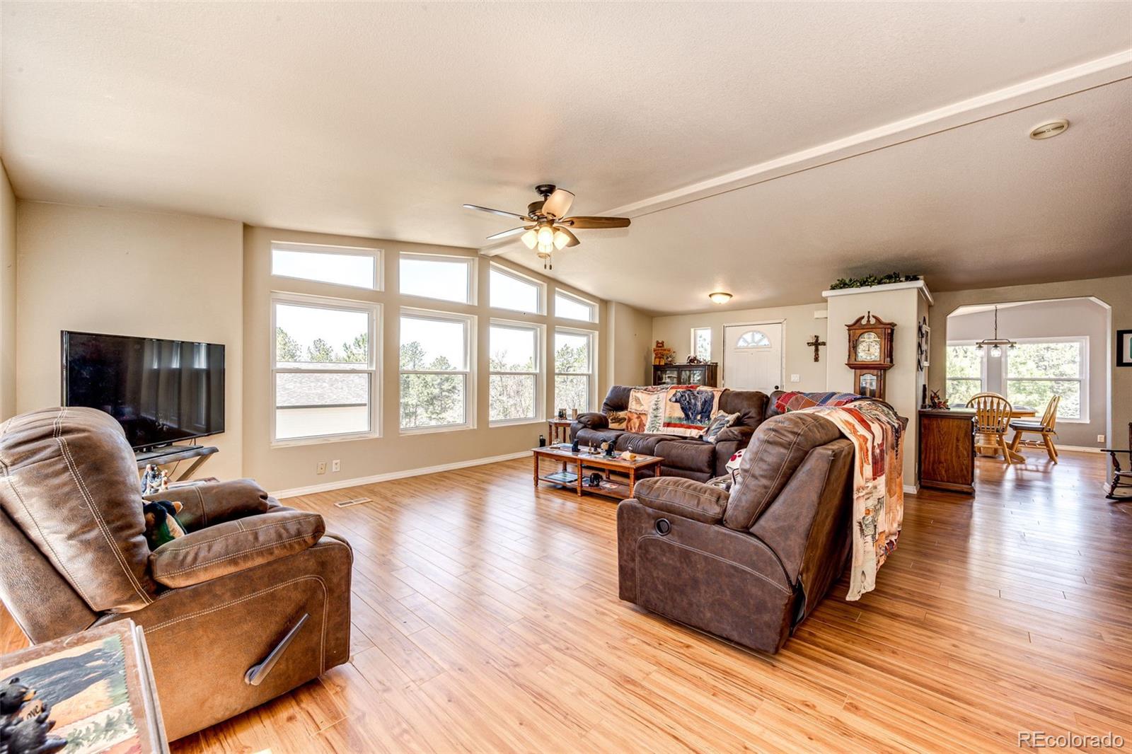 36810 View Ridge Drive Elizabeth, CO 80107 - Photo 18 of 46 a living room with furniture fireplace and wooden floor