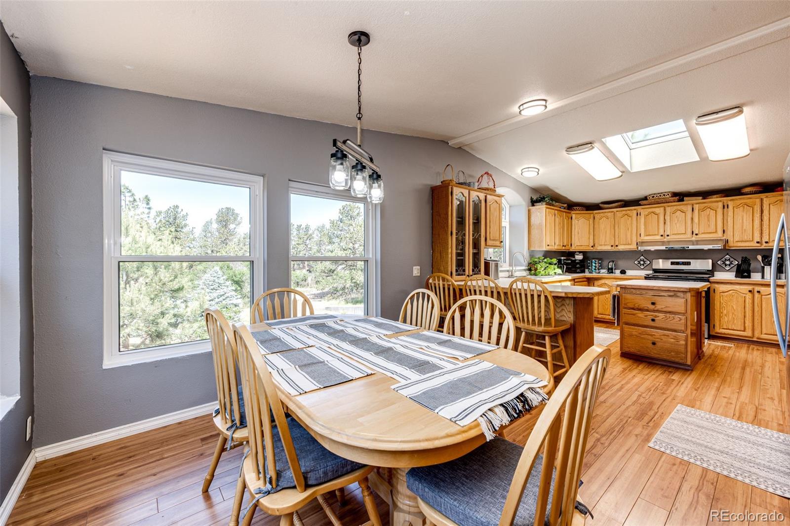 36810 View Ridge Drive Elizabeth, CO 80107 - Photo 24 of 46 a view of a dining room and livingroom with furniture wooden floor a chandelier