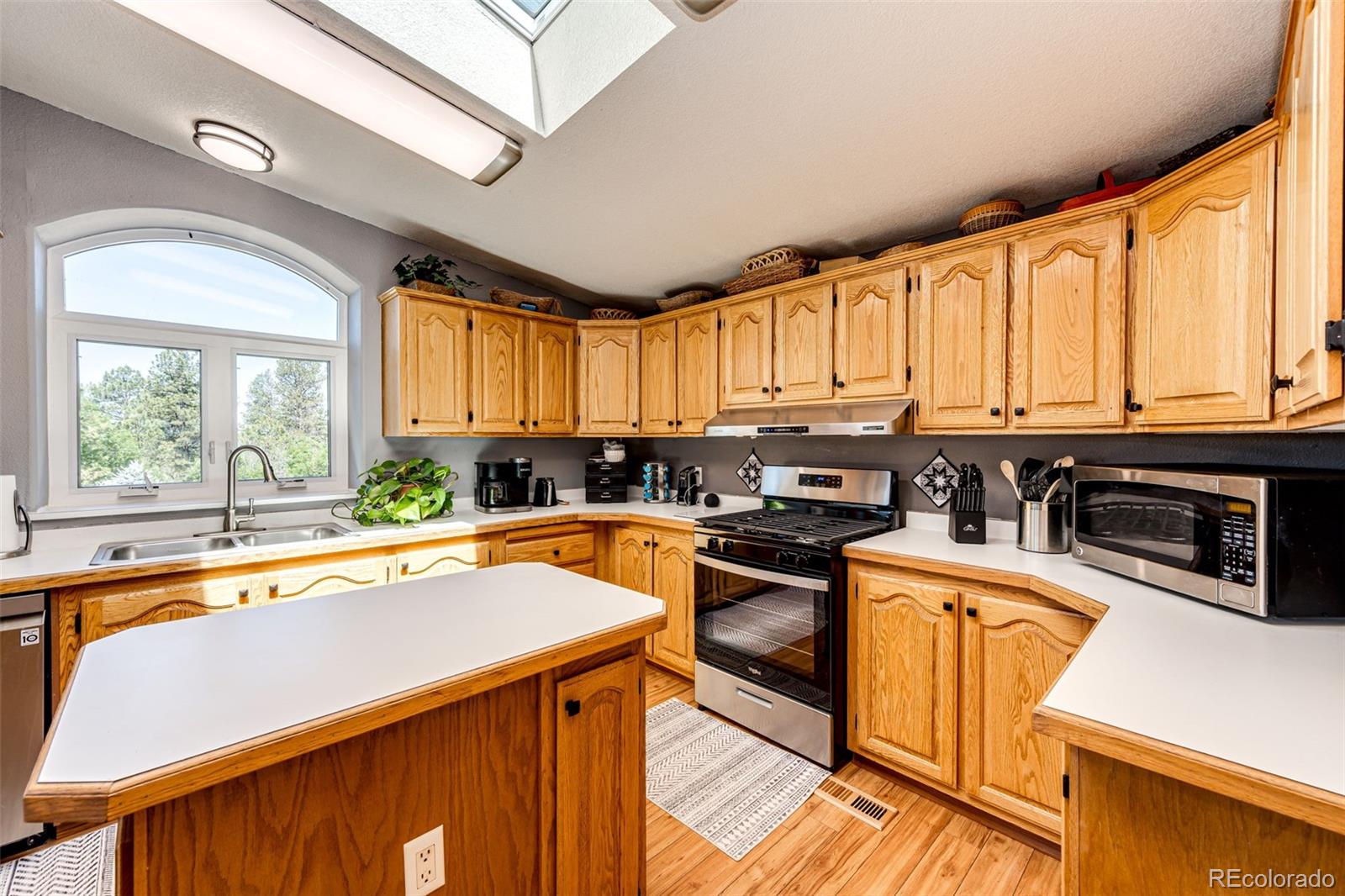 36810 View Ridge Drive Elizabeth, CO 80107 - Photo 27 of 46 a kitchen with stainless steel appliances a stove sink and cabinets