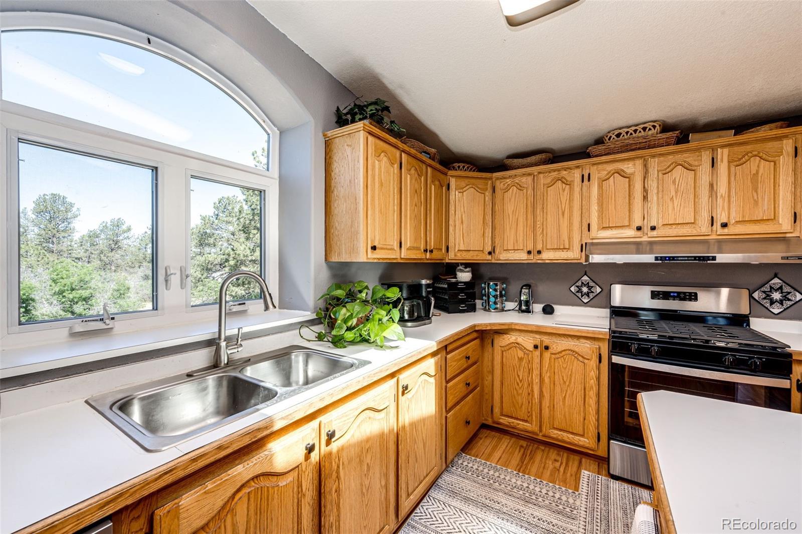 36810 View Ridge Drive Elizabeth, CO 80107 - Photo 28 of 46 a kitchen with granite countertop a sink and a counter top space