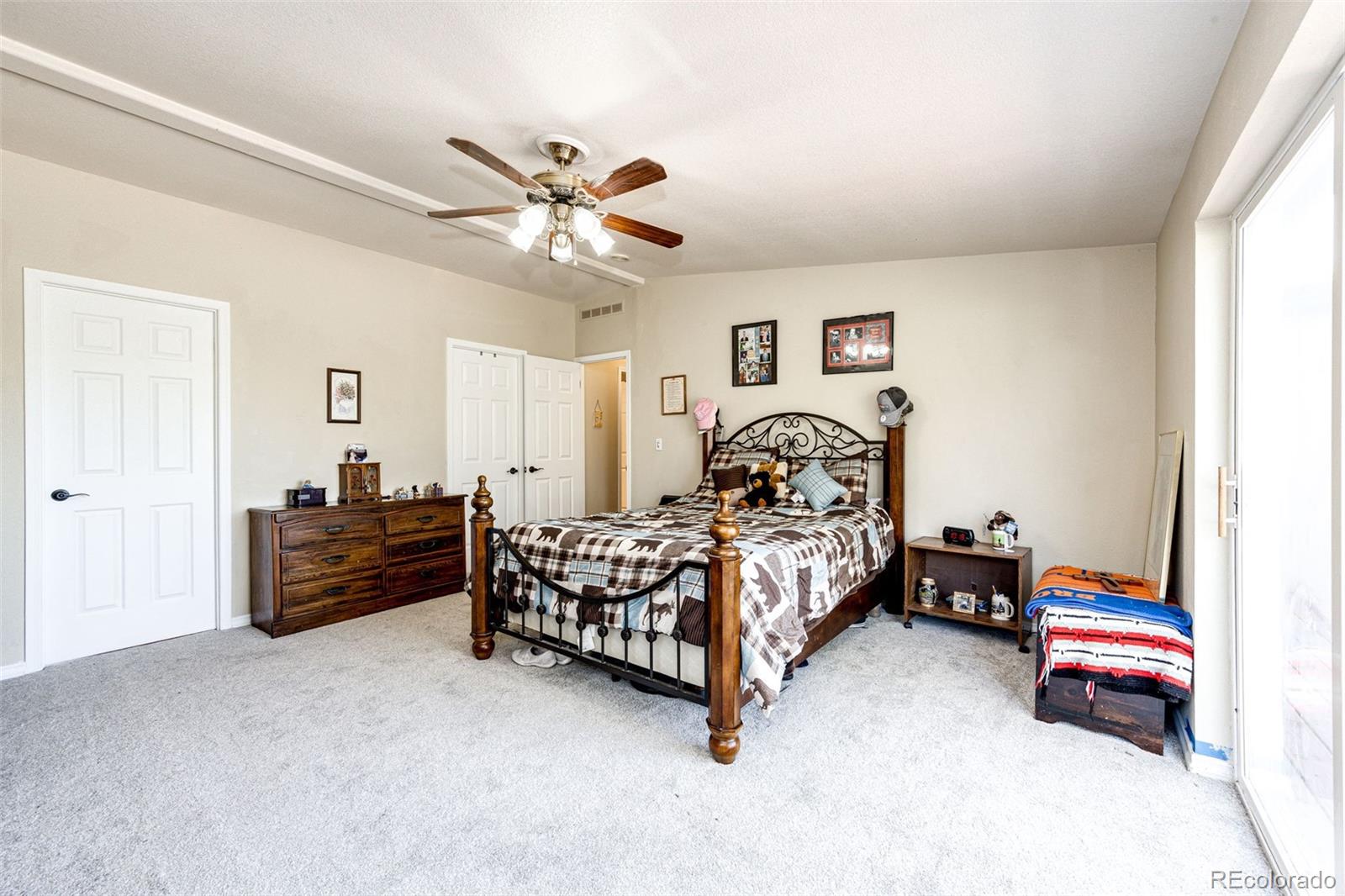 36810 View Ridge Drive Elizabeth, CO 80107 - Photo 31 of 46 a bedroom with a bed and a chandelier