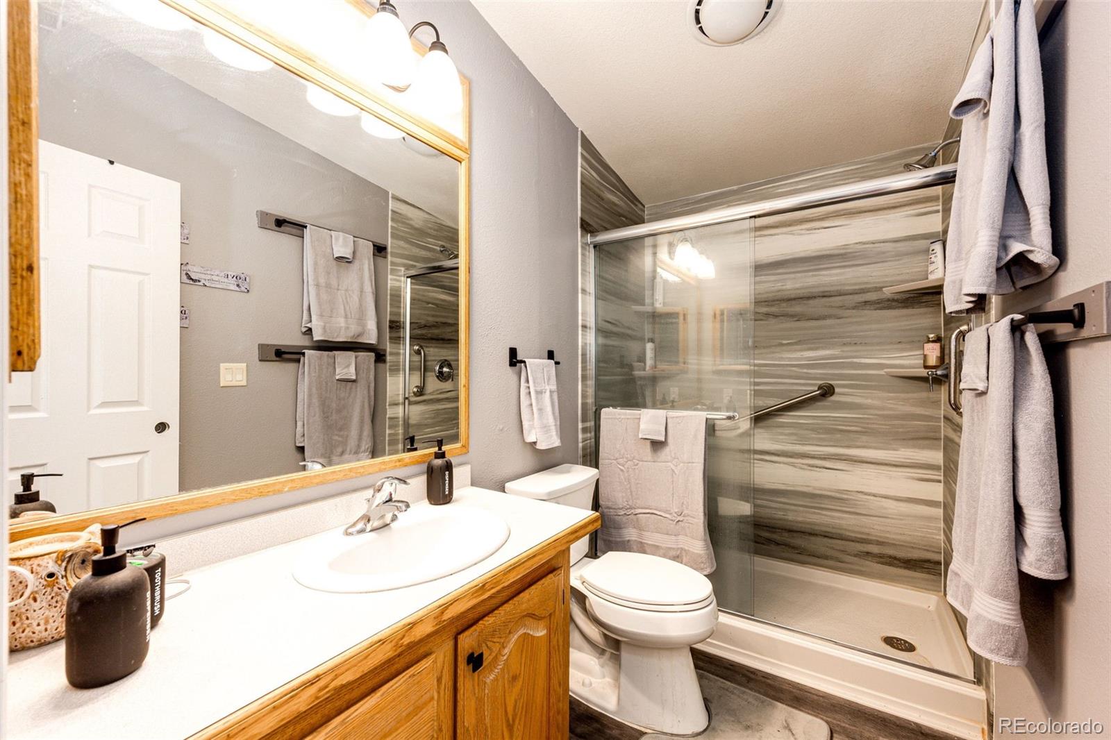36810 View Ridge Drive Elizabeth, CO 80107 - Photo 37 of 46 a bathroom with a sink a toilet and shower