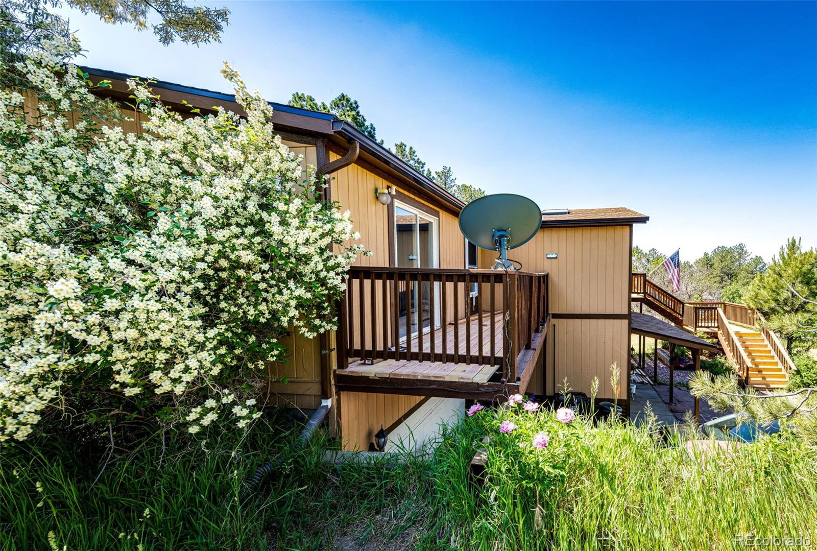 36810 View Ridge Drive Elizabeth, CO 80107 - Photo 44 of 46 a view of a house with a small yard and wooden fence