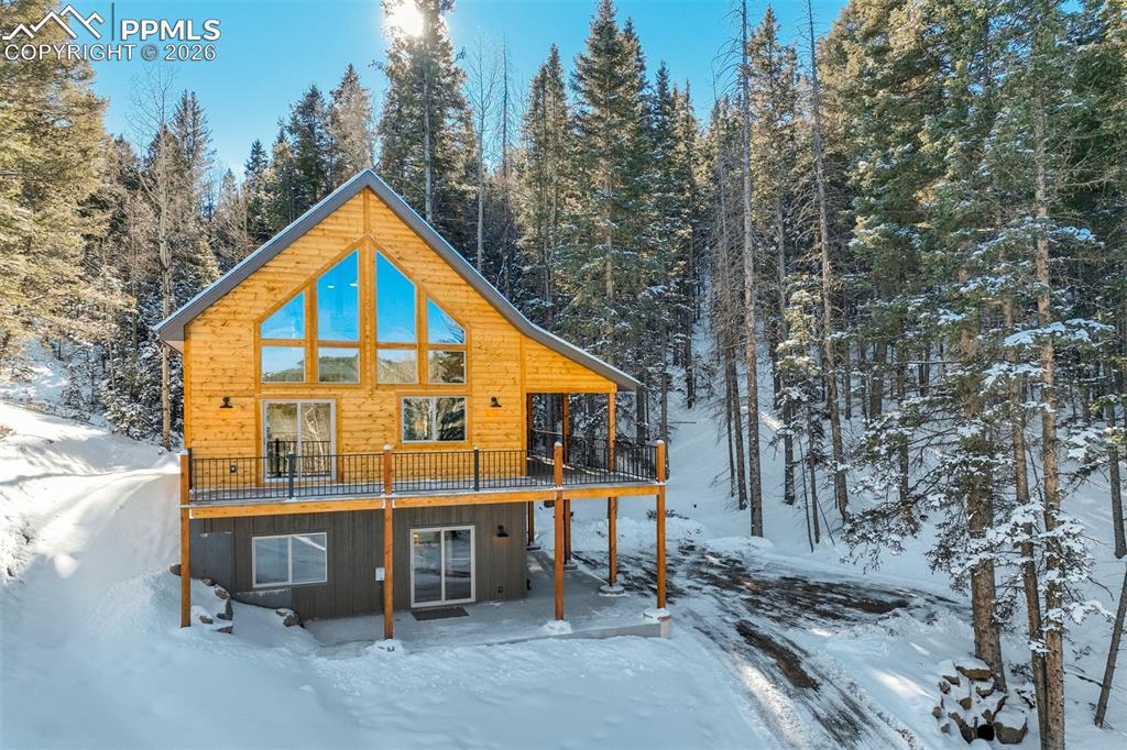 a view of a house with a yard and sitting area
