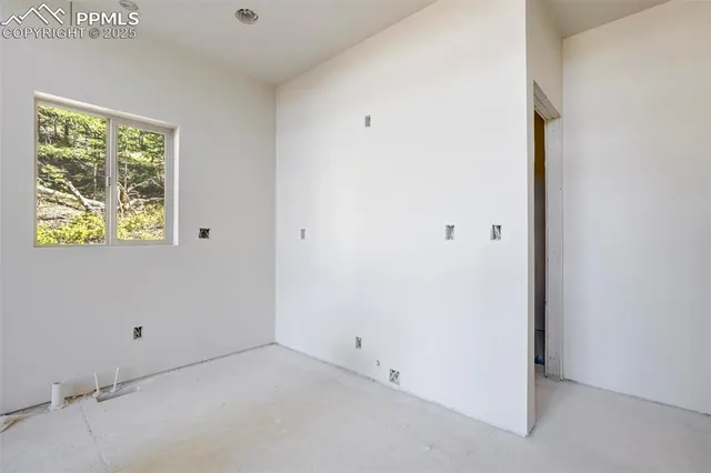 a very nice looking room with a large window and chandelier