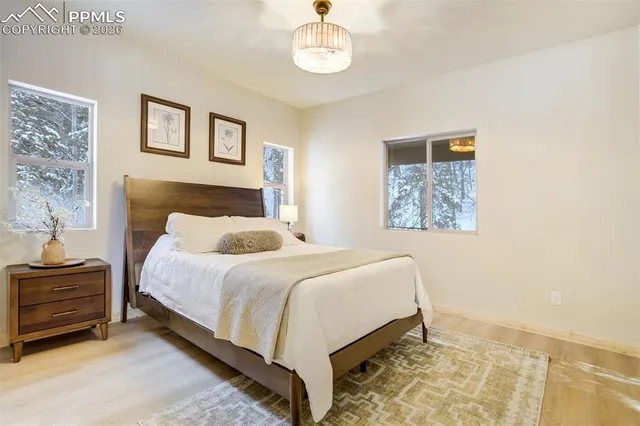 a bedroom with a bed and a lamp on table