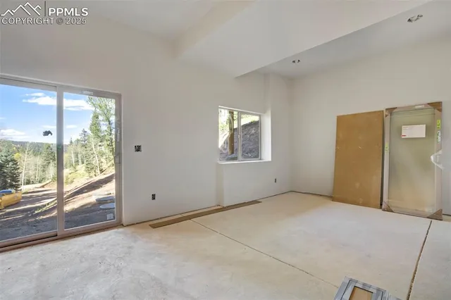 a large bedroom with a bed and a window