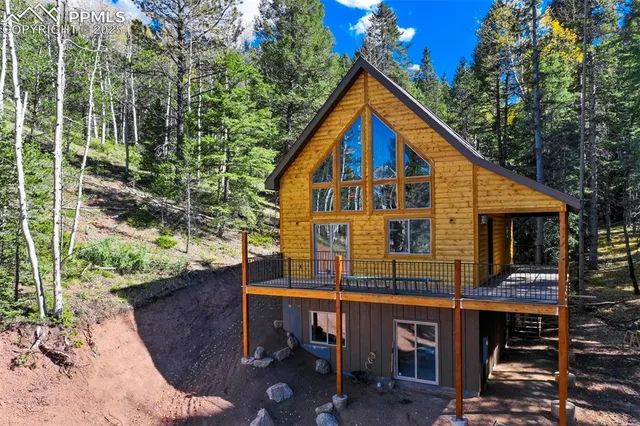 a view of house with backyard and seating area