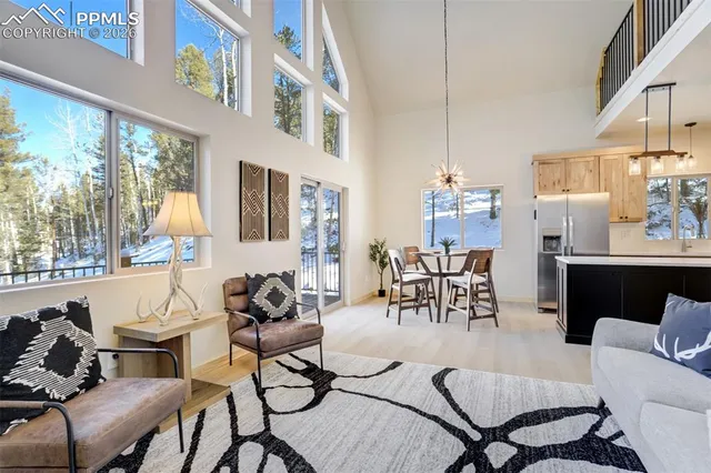 a kitchen with stainless steel appliances granite countertop white cabinets a stove a microwave and a refrigerator