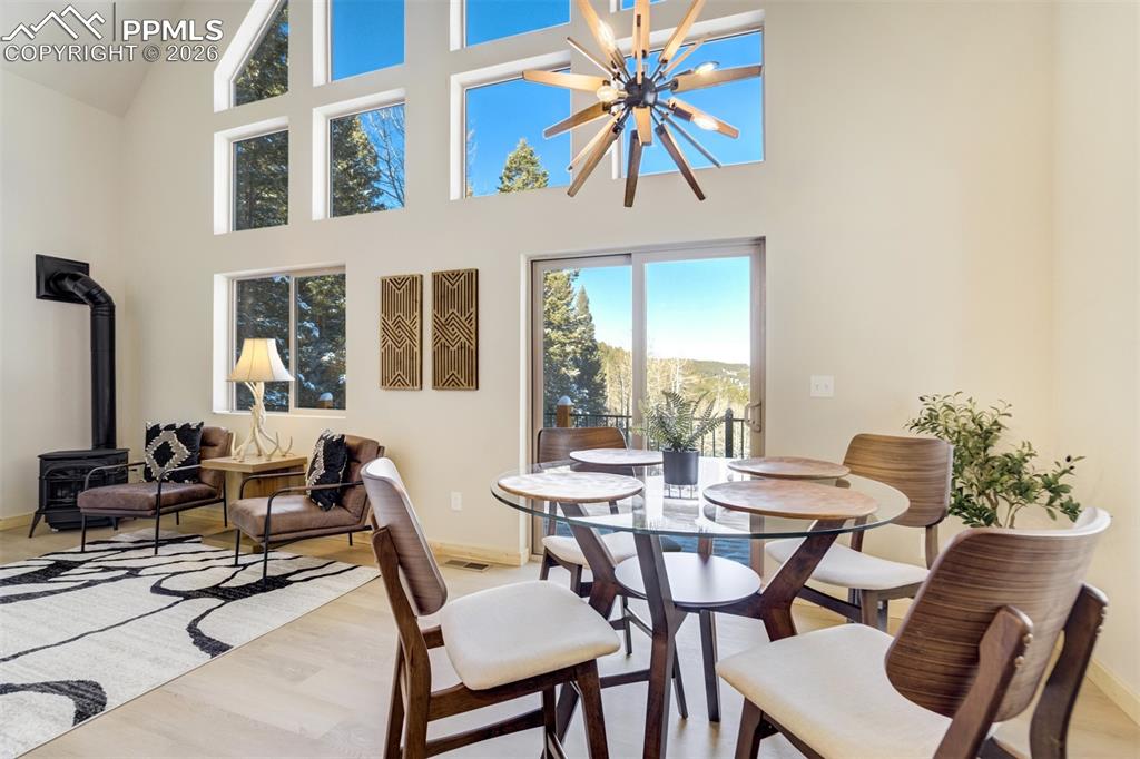 162 Kernite Lane Divide, CO 80814 - Photo 9 of 29 a dining room with furniture a rug and a floor to ceiling window