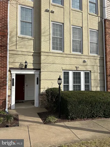 a view of a brick building next to a yard