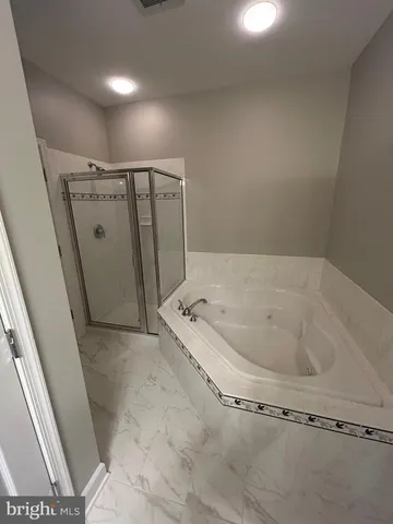 a bathroom with a glass door shower