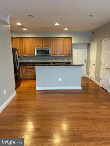 a view of kitchen with cabinets and wooden floor